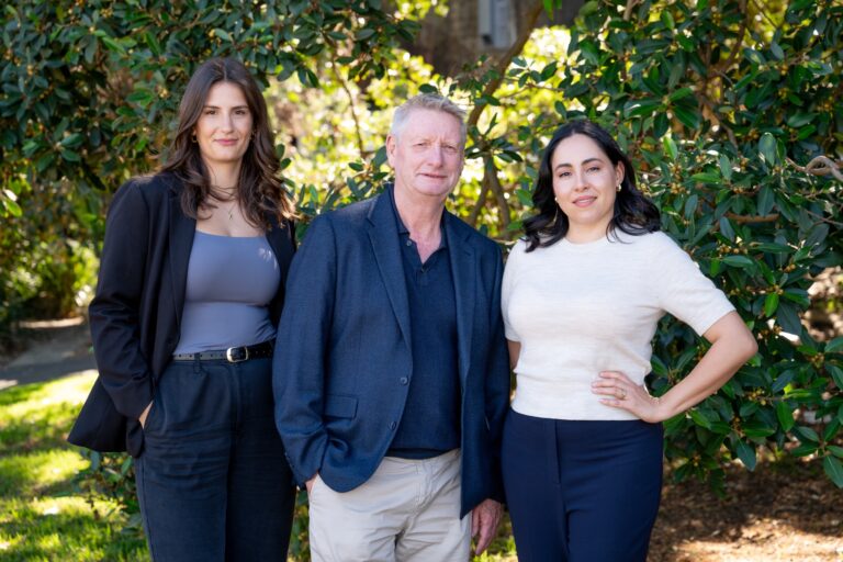 Portrait of three Palin colleagues standing outdoors among greenery